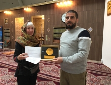 A woman presenting a letter to a man